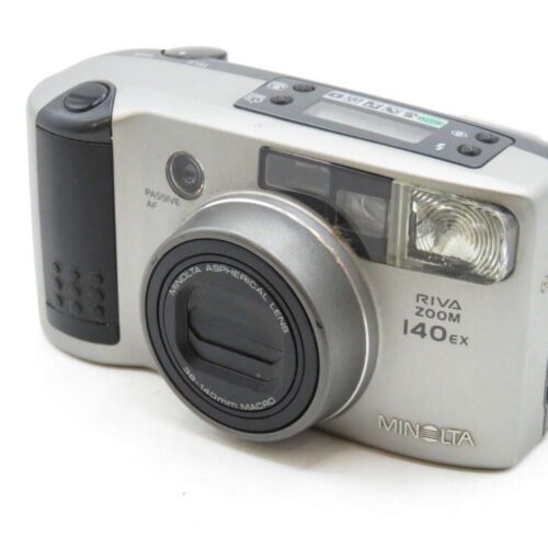 A Minolta Riva Zoom 140ex compact film camera with a silver body, lens, and flash visible.