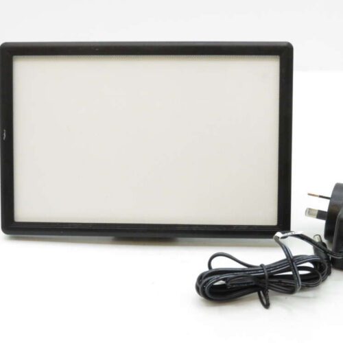Rectangular LED light panel with a black frame, accompanied by a power adapter with a plug.