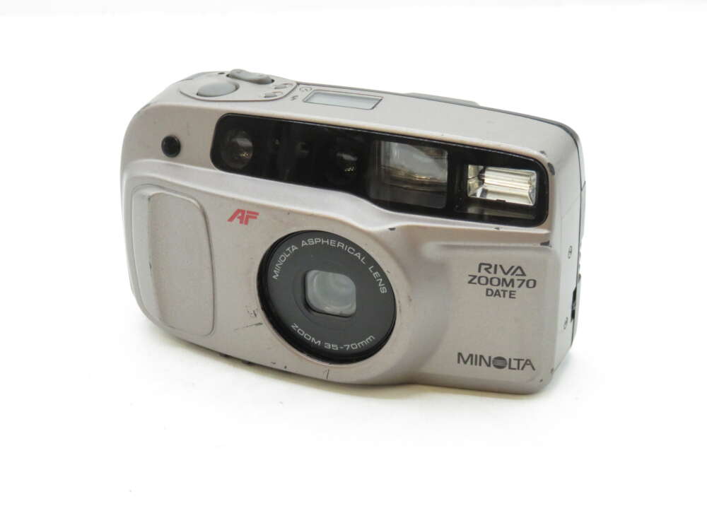 IMG_3209 A silver Minolta Riva Zoom 70 Date camera with a visible flash and a lens marked "Zoom 35-70mm."