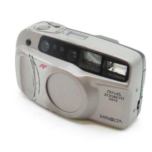 A silver Minolta Riva Zoom 70 Date camera featuring a lens cover and flash.