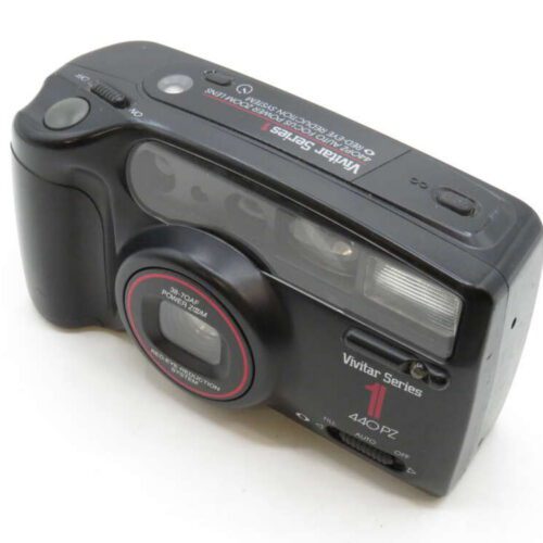 Black Vivitar Series 1 440PZ camera with a zoom lens and visible flash on a white background.