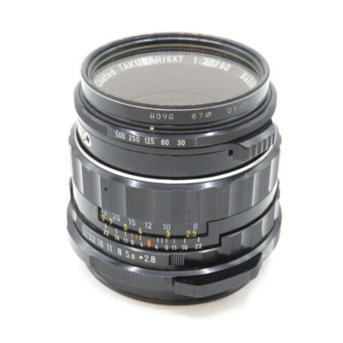 A vintage Takumar 6x7 camera lens with focus and aperture rings, markings range from f/2.8 to f/32.