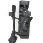 A professional black Canon video camera with dual XLR audio inputs, a side handle, and an eyepiece viewfinder.