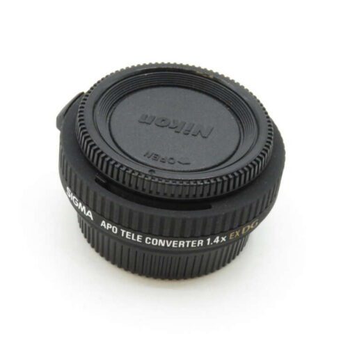 A black Nikon APO teleconverter 1.4x lens with a protective cover.
