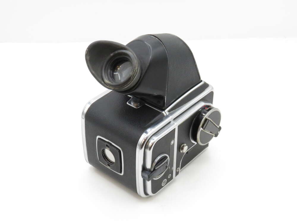 Vintage medium format camera with a waist-level viewfinder and a black and silver body.