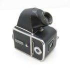 A vintage black and silver medium format camera with a waist-level viewfinder and visible winding knob.