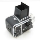 A vintage medium format camera with a waist-level viewfinder and black and silver detailing.