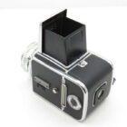 A vintage black camera with a waist-level viewfinder and silver detailing.