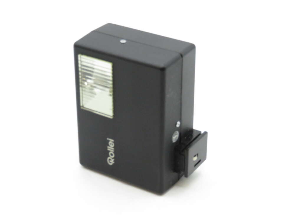 IMG_3555 A black Rollei camera flash unit with a clear light cover and mounting bracket.