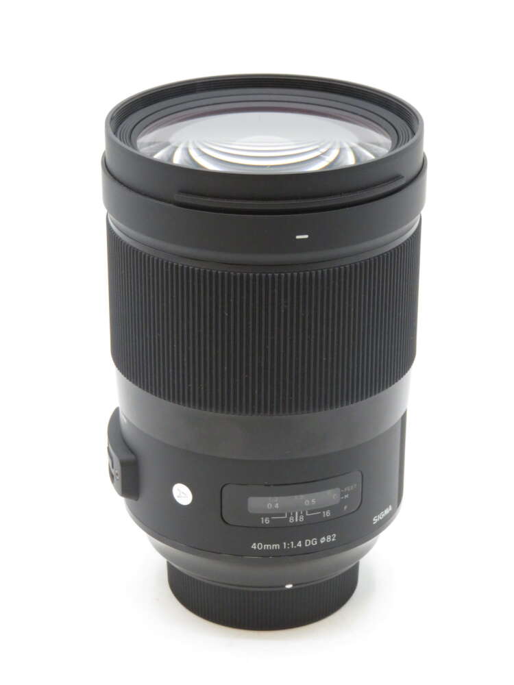 IMG_3562 A black Sigma 40mm f/1.4 DG HSM Art lens with a focus range scale on its side.