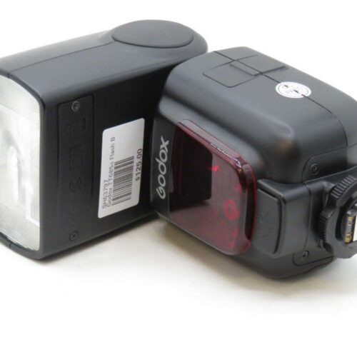 Two black Godox camera flashes with visible barcode stickers, placed side by side.