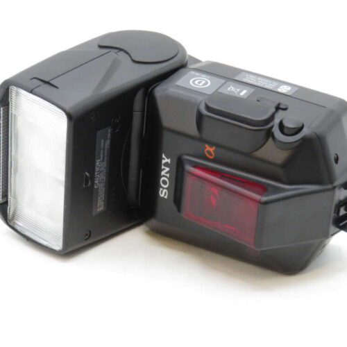 A black external camera flash with a Sony logo and various buttons and controls, including a red light panel.