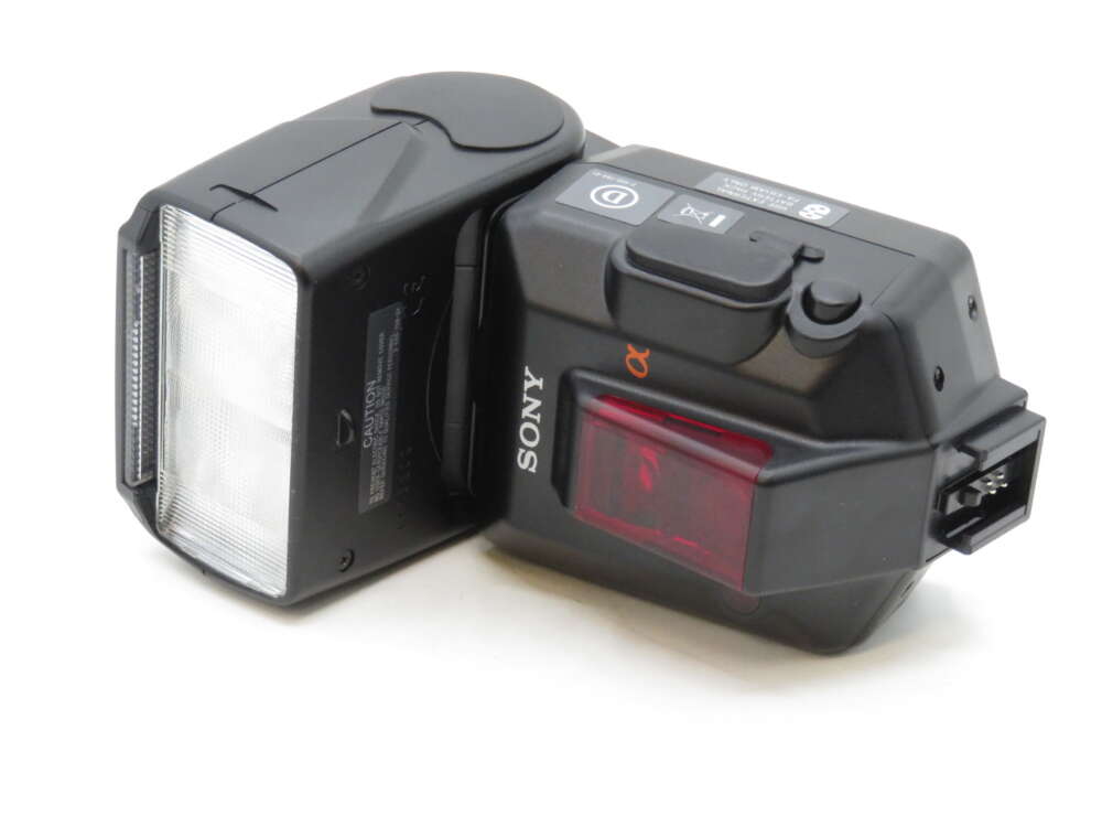 IMG_3565 A black external camera flash with a Sony logo and various buttons and controls, including a red light panel.
