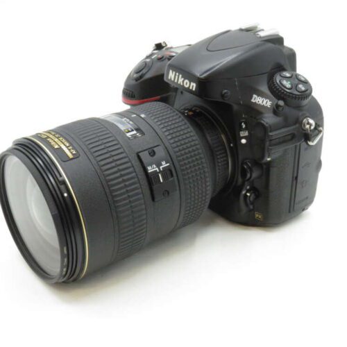 A Nikon D800E DSLR camera with a large zoom lens attached, displayed against a white background.