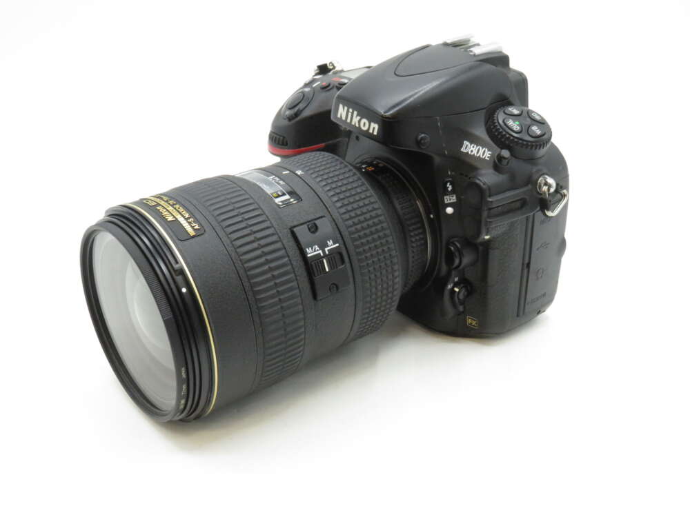 IMG_3584 A Nikon D800E DSLR camera with a large zoom lens attached, displayed against a white background.