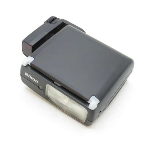 A black Nikon speedlight flash unit with a foldable design and visible lens on the front.