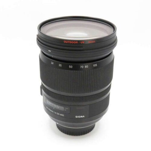 A Sigma camera lens with visible distance markings and a UV filter attached.