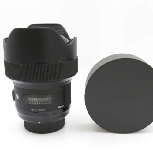 A camera lens with a wide aperture, next to a cylindrical lens cap or cover, on a white background.