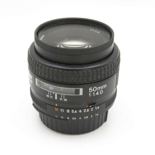 A 50mm camera lens with a 1:1.4 aperture, featuring focus and aperture rings marked with numbers.
