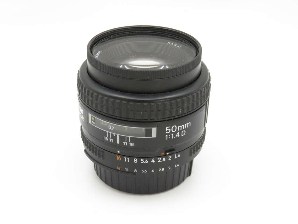 IMG_3642 A 50mm camera lens with a 1:1.4 aperture, featuring focus and aperture rings marked with numbers.
