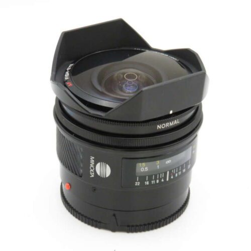 A Minolta camera lens with a wide-angle hood, focus dial, and aperture markings.