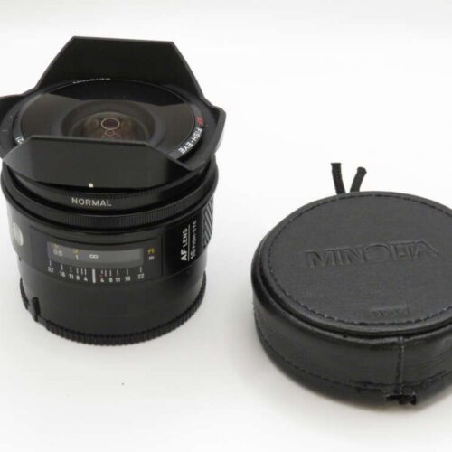 A fisheye camera lens with a Minolta branded case beside it.