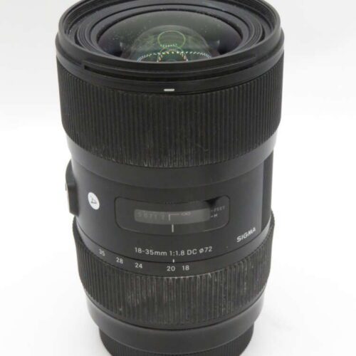 A Sigma 18-35mm f/1.8 DC HSM camera lens with focus and zoom rings, shown vertically on a plain background.