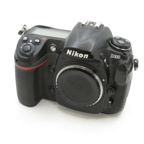 A Nikon D300 DSLR camera with a body cap on a white background.