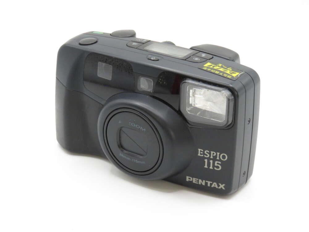 IMG_3787 A Pentax Espio 115 compact film camera with a black body and visible lens and flash.