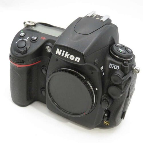 Nikon D700 DSLR camera body with various control dials and buttons on a white background.