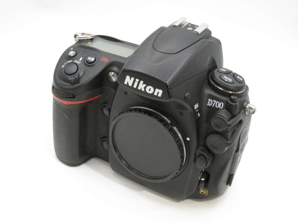 IMG_3799 Nikon D700 DSLR camera body with various control dials and buttons on a white background.