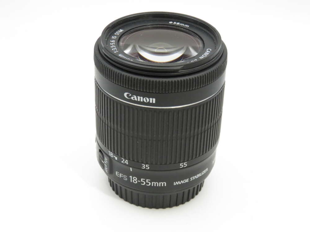 IMG_3807 A Canon EFS 18-55mm camera lens with image stabiliser, showing its zoom range markings on a white background.
