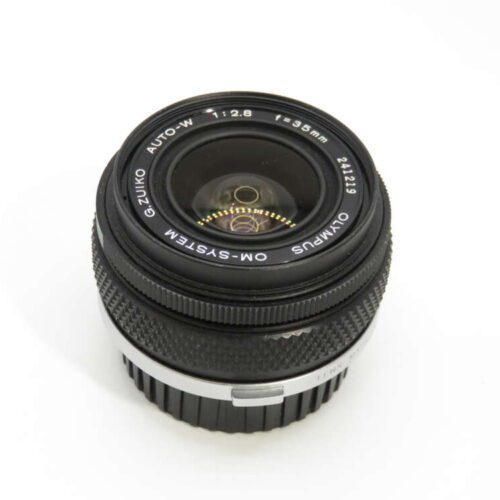 A vintage Olympus Zuiko 28mm f/2.8 camera lens with a black body and silver ring, viewed from above.