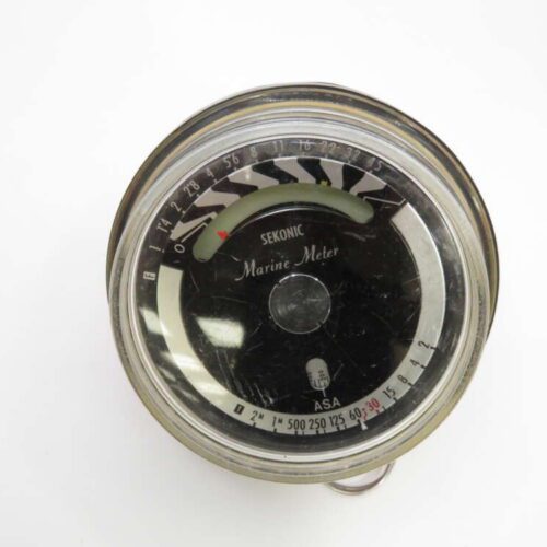 A vintage Sekonic Marine Meter with a round face and measurement markings around the edge.