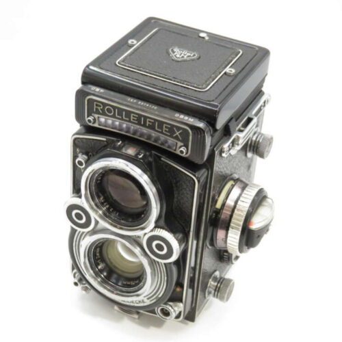 A vintage Rolleiflex twin-lens reflex camera with a black body and silver detailing, featuring two prominent lenses on the front.