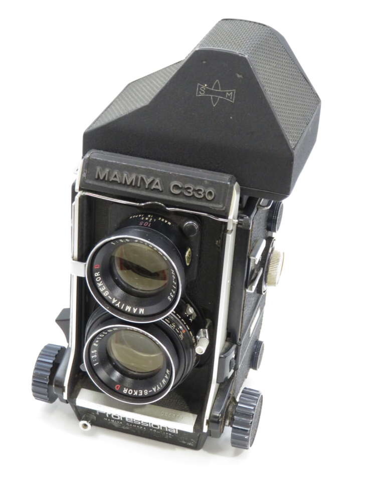 IMG_3871 A vintage Mamiya C330 twin-lens reflex camera with two large lenses and a robust black body.