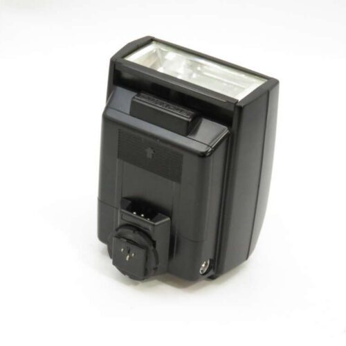 Camera flash unit with a rectangular flash head, hot shoe mount, and control panel on the back, set against a plain background.