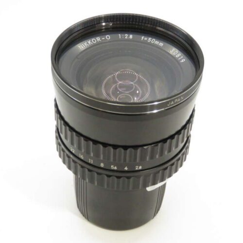 A black Nikkor-O 50mm camera lens with a wide aperture ring and visible text detailing aperture settings.