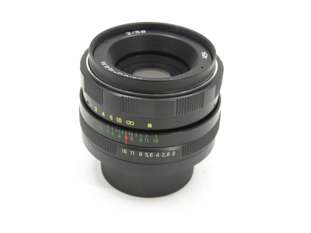 IMG_3913 A black camera lens with a focal length of 58mm and aperture settings marked in colourful numbers on the barrel.