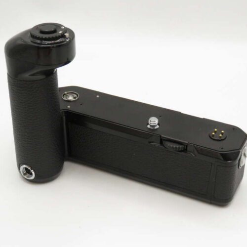A black camera grip with a textured surface and control buttons, designed for attachment to a camera body.