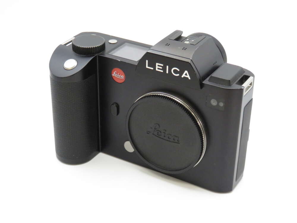 IMG_3995 A black Leica camera with a textured grip and lens cap, featuring the Leica logo prominently displayed.