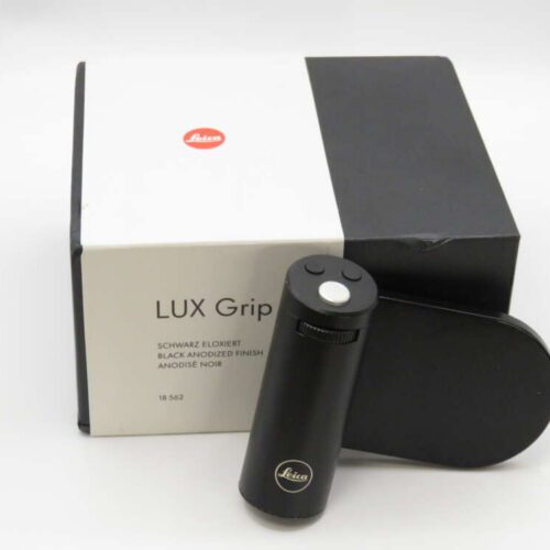 Leica Lux Grip in black anodised finish with its packaging beside it.