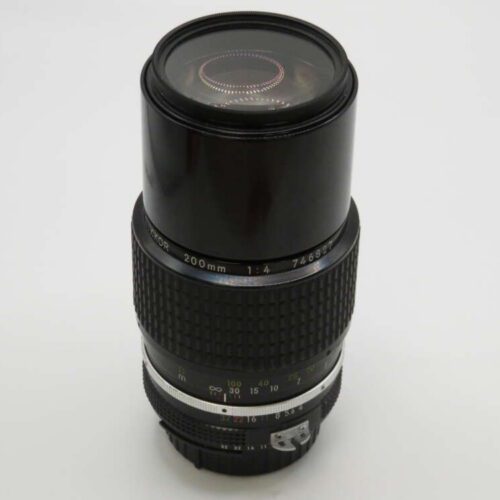 A telephoto camera lens with a textured grip and focus markings on a white background.