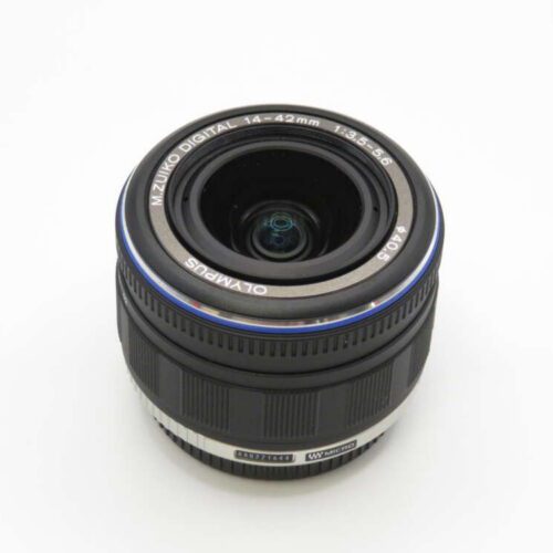 A black Olympus M.Zuiko Digital 14-42mm camera lens with a blue ring around the front.