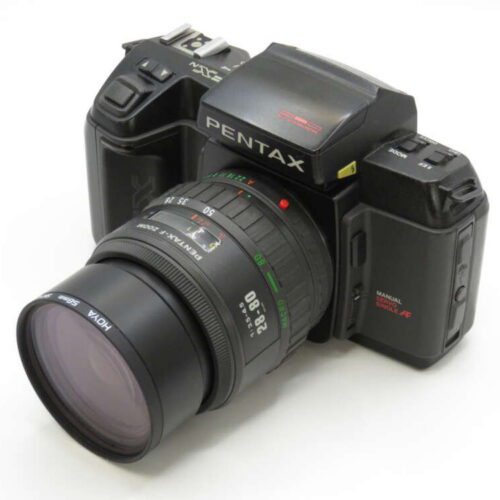 Black Pentax camera featuring a zoom lens and various control buttons.