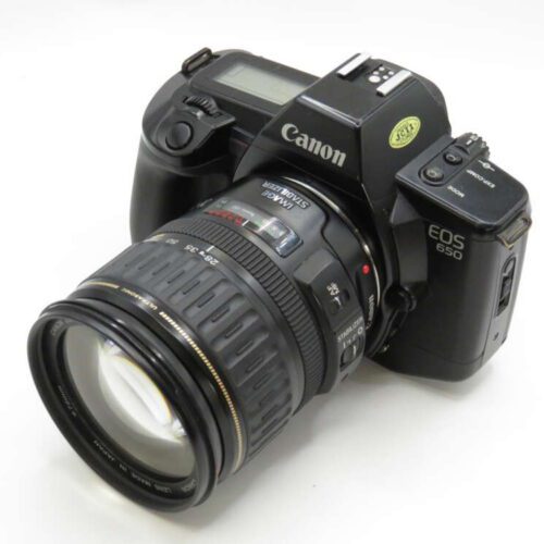 A Canon EOS 650 film camera with a zoom lens attached, viewed at an angle on a plain background.