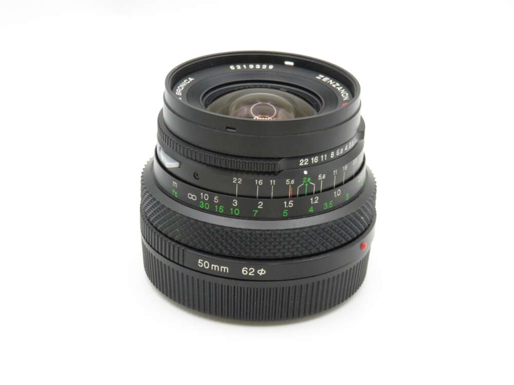 IMG_4097 A 50mm camera lens with manual focus and aperture settings, featuring distance and aperture scales in green and white markings.