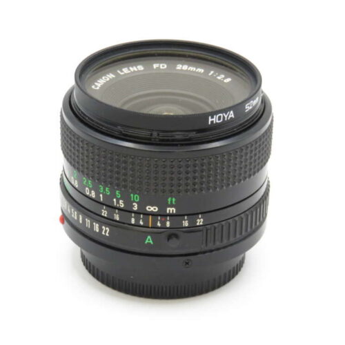 A Canon 28mm f/2.8 FD camera lens with a Hoya filter, featuring manual focus distance indicators and aperture settings.