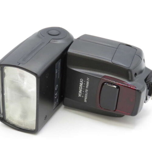 A Yongnuo Speedlite YN560-IV external camera flash with a rectangular shape and control buttons.