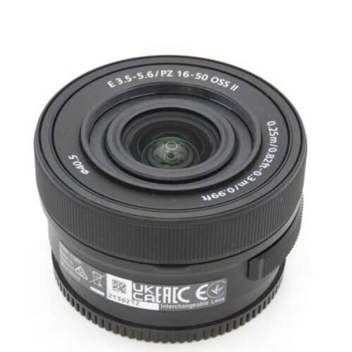 A black 16-50mm interchangeable camera lens with visible specifications around the rim.